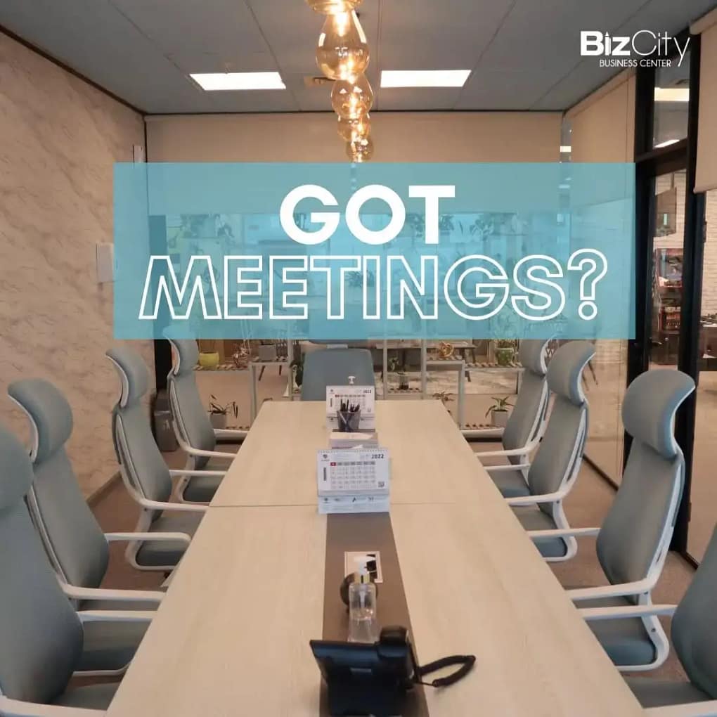 Modern luxury meeting room in Dubai with conference table, ergonomic chairs, and presentation screen at BizCity Group business center.