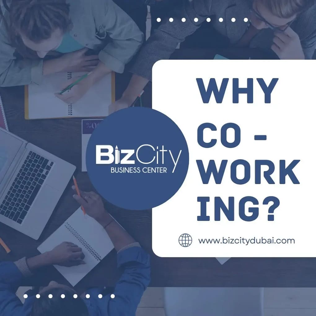 Professionals collaborating around a table in a modern coworking space, working together on laptops and documents.